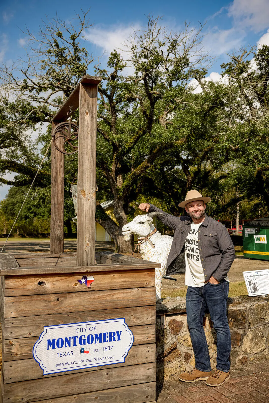 Chet Garner with the Monty the Goat statue in Montgomery, Texas
