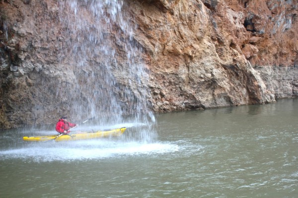 Chet kayaking under waterfall